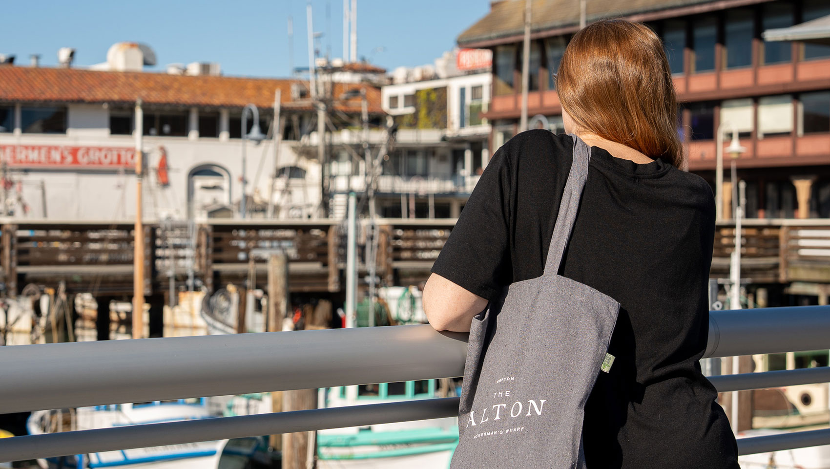 woman with Alton tote bag looks out over Fisherman's Wharf