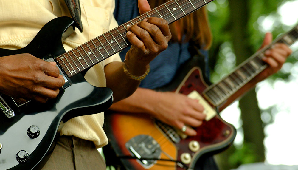 Two guitar players at an outdoor concert