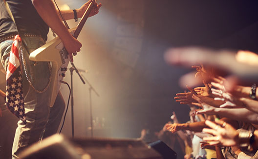 guitar player and fans reaching out to him